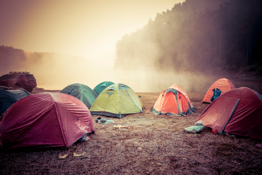 an image of many camping tents in a misty area
